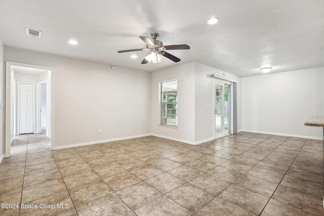 empty room featuring ceiling fan, light tile patterned floors, recessed lighting, and baseboards