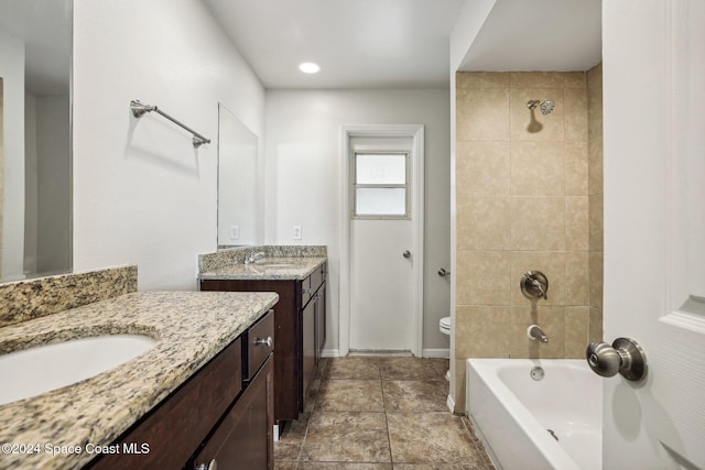 full bathroom with vanity, toilet, and tiled shower / bath combo