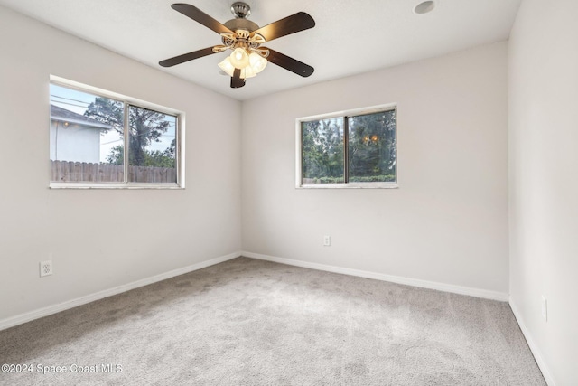 spare room with carpet floors, baseboards, and ceiling fan