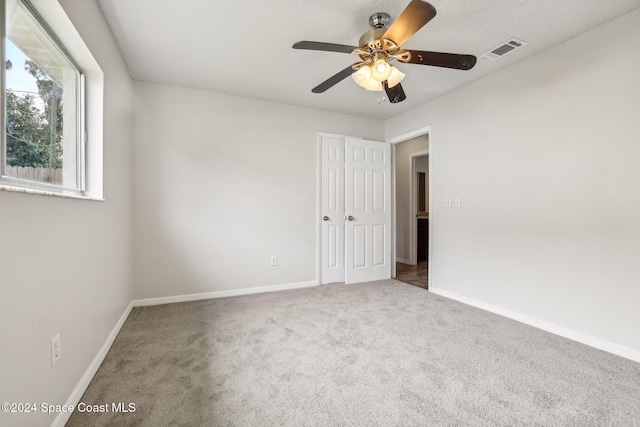 spare room with ceiling fan and carpet floors