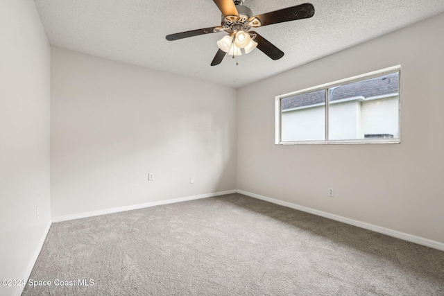 spare room featuring carpet flooring, ceiling fan, and a textured ceiling