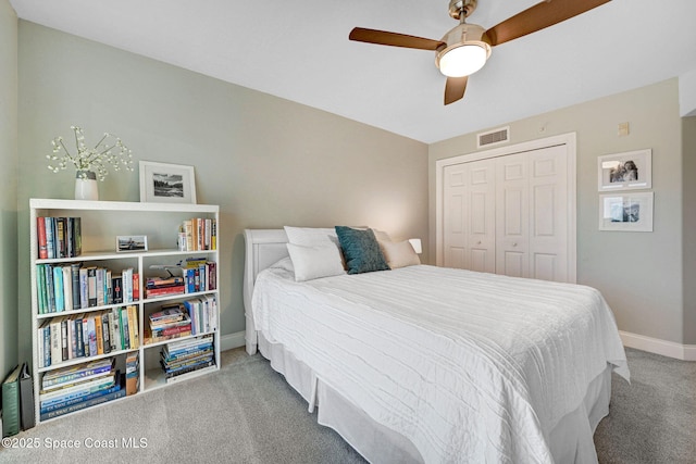 bedroom featuring ceiling fan, a closet, and carpet