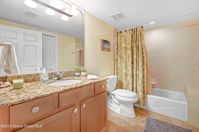 full bathroom featuring shower / bath combo, vanity, tile patterned flooring, toilet, and a textured ceiling