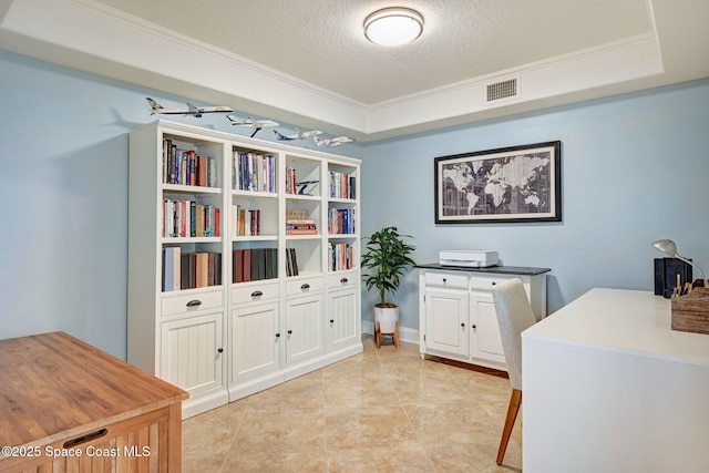 office space featuring a textured ceiling, a tray ceiling, and ornamental molding