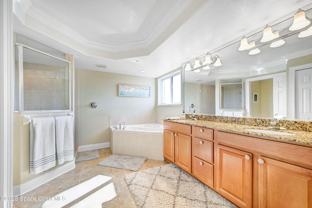 bathroom featuring tile patterned floors, ornamental molding, vanity, a tray ceiling, and separate shower and tub