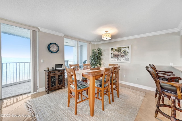 dining area with plenty of natural light, a water view, light tile patterned floors, and ornamental molding