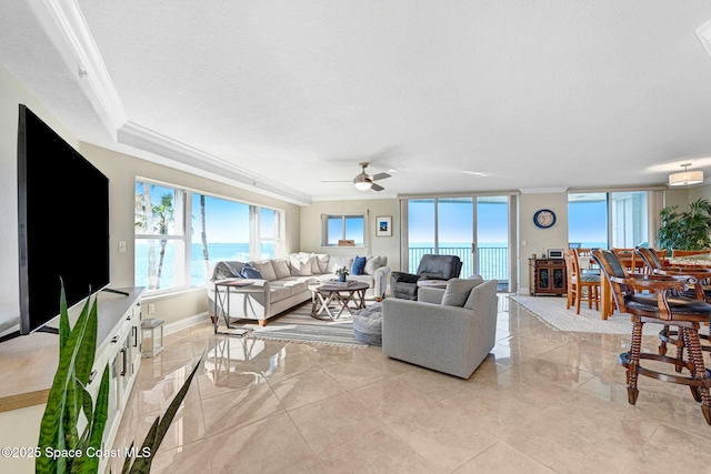 living room featuring ceiling fan, crown molding, a water view, and a textured ceiling