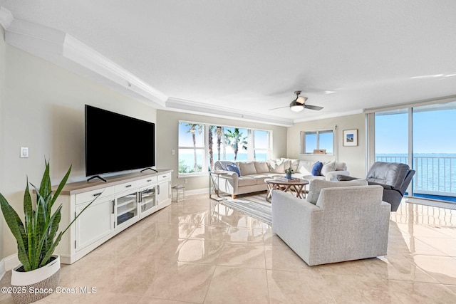 living room with ceiling fan and ornamental molding