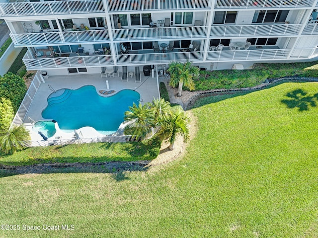 view of pool with a yard