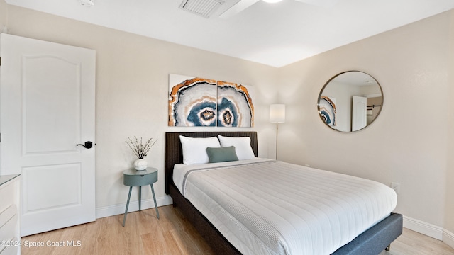 bedroom featuring light hardwood / wood-style floors and ceiling fan