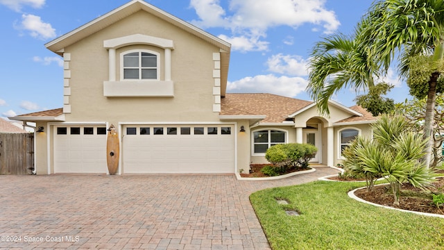 front of property featuring a front yard and a garage