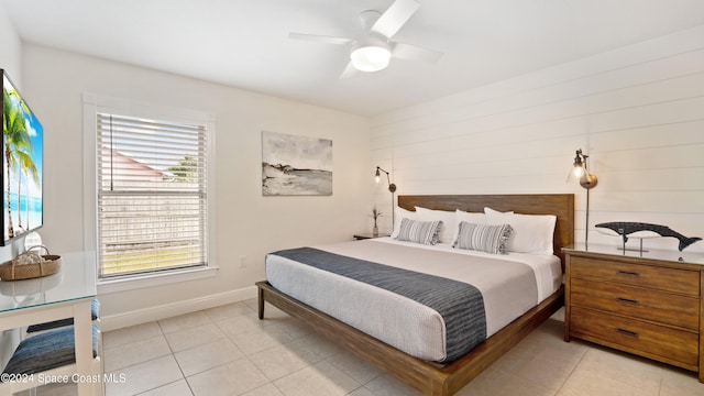 bedroom featuring light tile patterned floors and ceiling fan