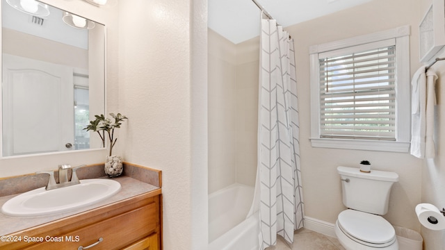 full bathroom featuring vanity, toilet, tile patterned floors, and shower / tub combo