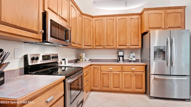 kitchen featuring appliances with stainless steel finishes and light tile patterned floors