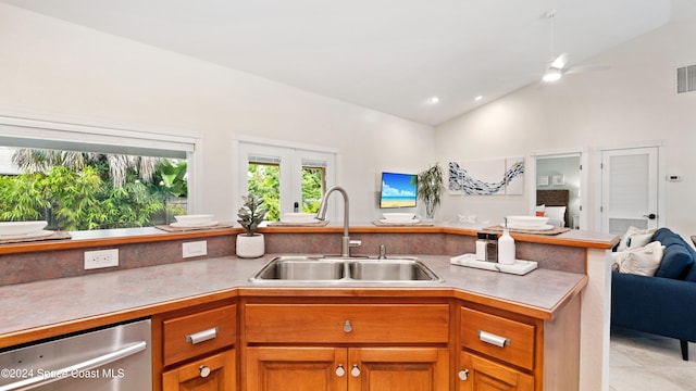 kitchen featuring dishwasher, kitchen peninsula, sink, light tile patterned flooring, and ceiling fan