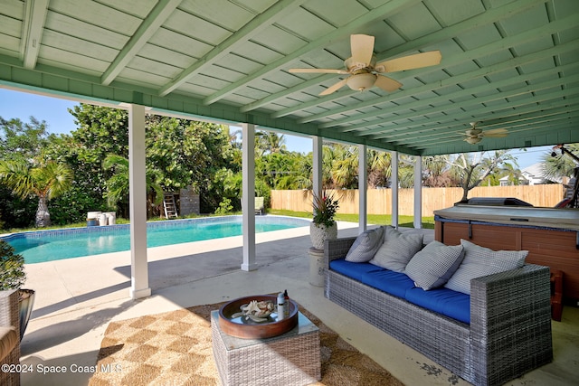 view of swimming pool with a patio, a hot tub, and ceiling fan