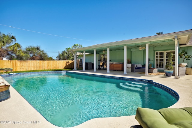 view of swimming pool with an outdoor living space, ceiling fan, and a patio