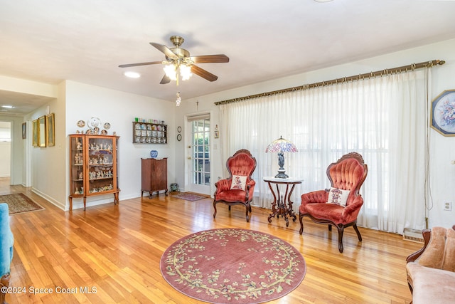 sitting room featuring hardwood / wood-style flooring and ceiling fan