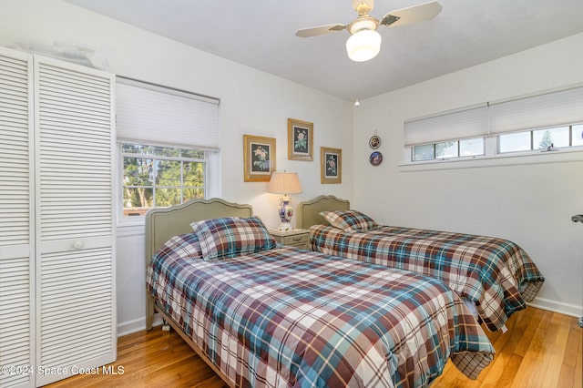 bedroom featuring a closet, light wood-type flooring, and ceiling fan