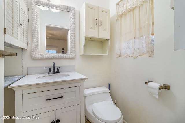 bathroom with toilet and vanity