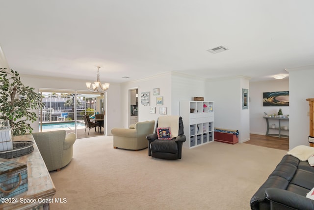 carpeted living room with crown molding and an inviting chandelier