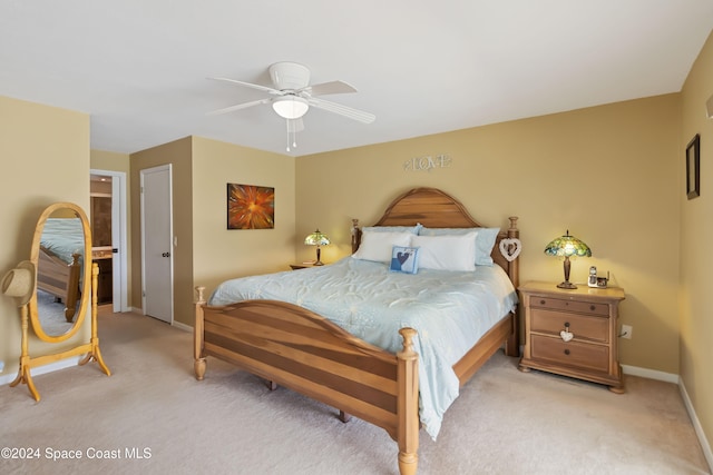 bedroom featuring light colored carpet and ceiling fan