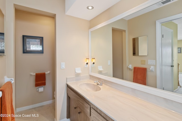 bathroom featuring vanity, toilet, and tile patterned floors