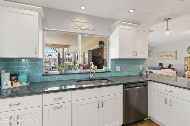 kitchen featuring white cabinetry, stainless steel dishwasher, light hardwood / wood-style flooring, decorative light fixtures, and sink