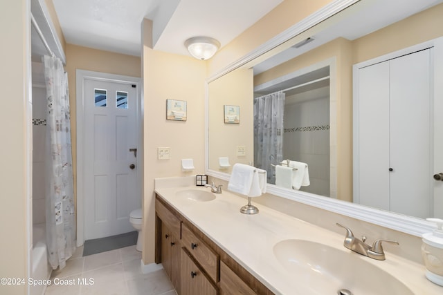 full bathroom with vanity, shower / tub combo with curtain, toilet, and tile patterned flooring