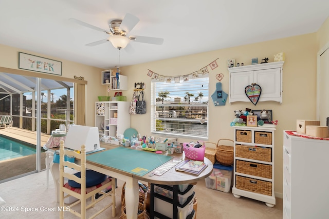 carpeted dining room with ceiling fan