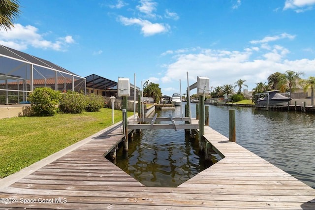 view of dock featuring a yard, a water view, and a lanai