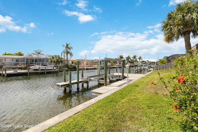 dock area featuring a water view and a lawn