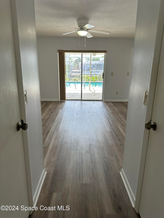 unfurnished room featuring ceiling fan and dark hardwood / wood-style floors