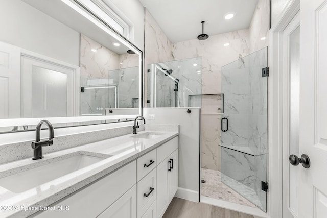 bathroom featuring vanity, a shower with shower door, and hardwood / wood-style flooring