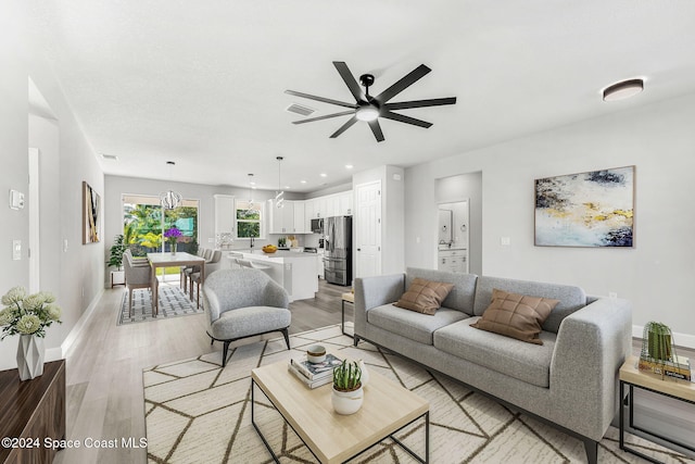 living room with ceiling fan and light hardwood / wood-style floors