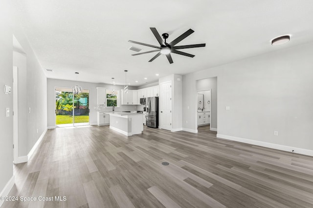 unfurnished living room with ceiling fan and light wood-type flooring