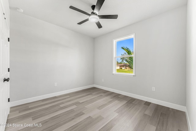 empty room featuring ceiling fan and light hardwood / wood-style flooring