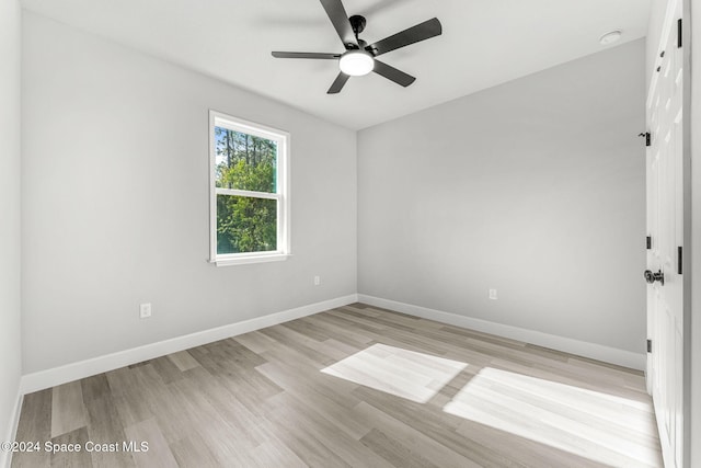 spare room featuring light hardwood / wood-style flooring and ceiling fan