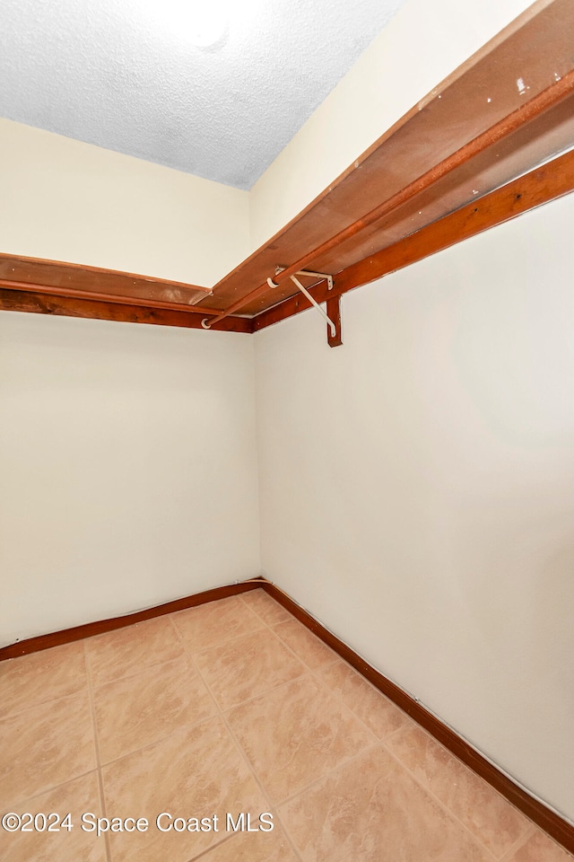 walk in closet featuring tile patterned flooring