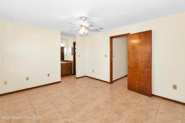 empty room with a textured ceiling and ceiling fan