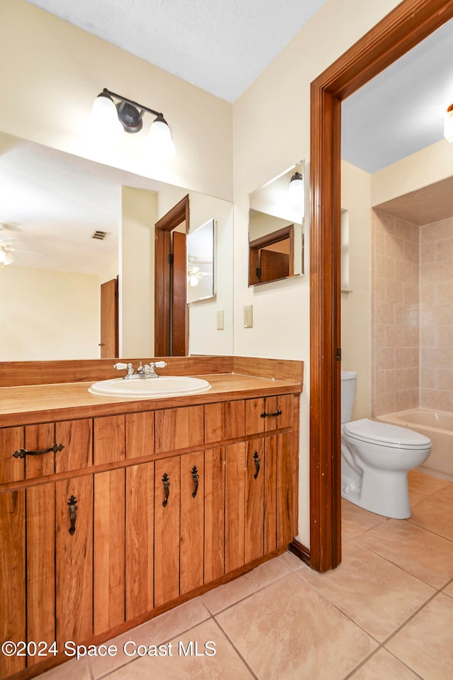 bathroom featuring toilet, vanity, tile patterned floors, and ceiling fan