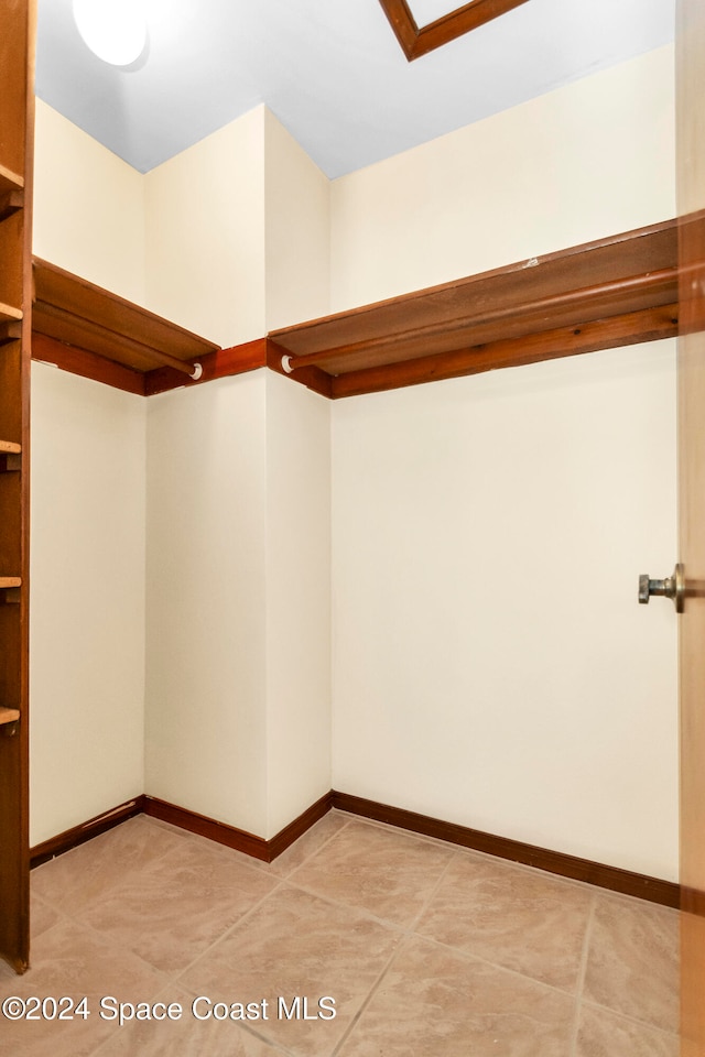 spacious closet featuring light tile patterned floors