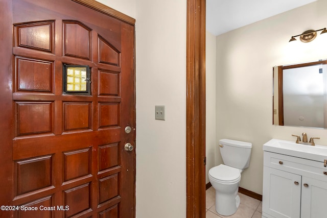 bathroom featuring tile patterned flooring, vanity, and toilet