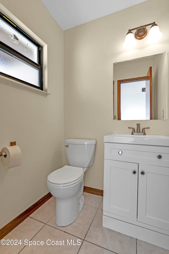 bathroom featuring toilet, vanity, and tile patterned floors