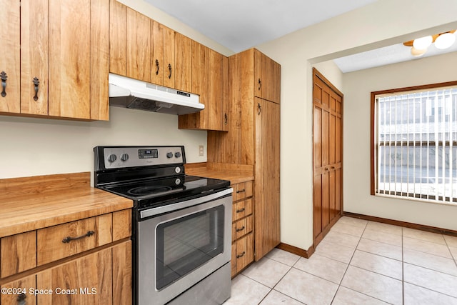 kitchen with light tile patterned floors and stainless steel range with electric cooktop