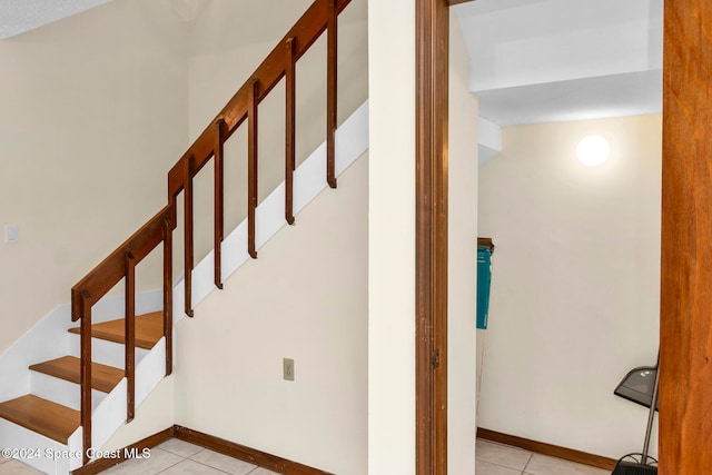 stairway with tile patterned flooring