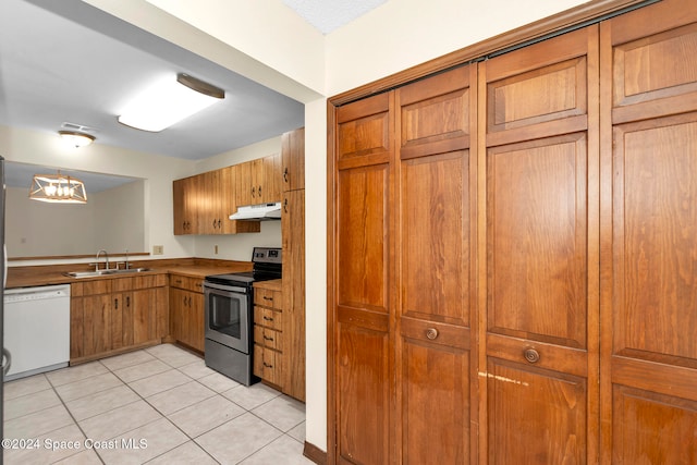 kitchen with stainless steel electric range, white dishwasher, sink, light tile patterned floors, and pendant lighting