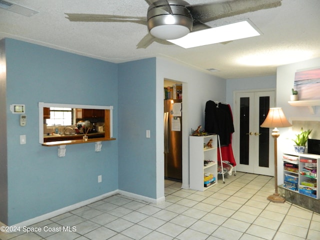 interior space with light tile patterned flooring and french doors