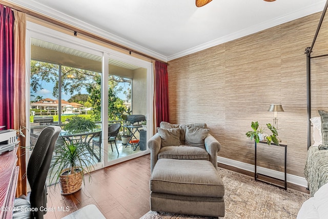 sitting room with ornamental molding and hardwood / wood-style floors