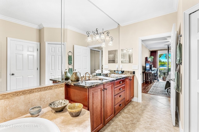 bathroom featuring vanity, crown molding, a bathing tub, and tile patterned floors